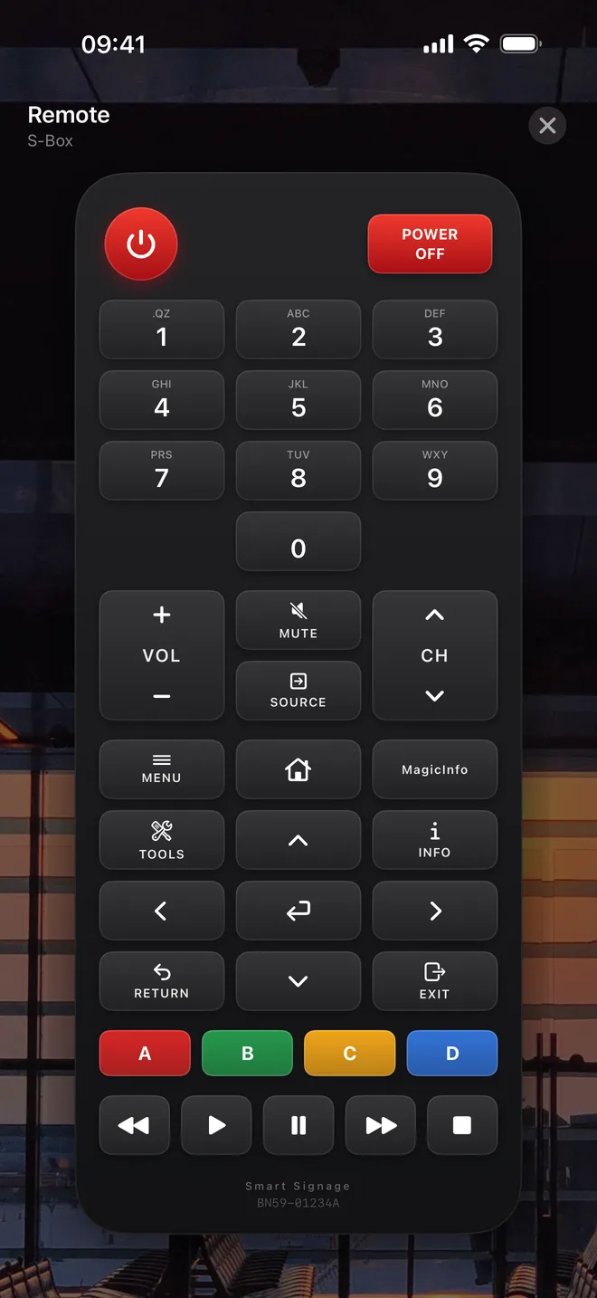 A full on-screen remote keypad with number, menu, arrow, colour and playback keys, over a photo of the sign's location.